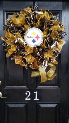 a black door with a yellow and silver wreath on it that says 21 st louis