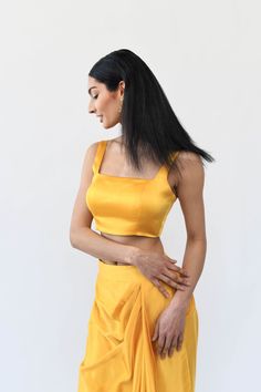 A must-have for any wardrobe, this mango colored blouse offers an elevated level of sophistication with its classic design. This beautiful sleeveless blouse is tailored with a low back design and has built-in padding for a flattering silhouette, while the adjustable hook closure on the back strap allows you to find you Chic Sleeveless Satin Crop Top, Chic Satin Sleeveless Crop Top, Elegant Sleeveless Satin Crop Top, Chic Fitted Sleeveless Crop Top, Padded Fitted Blouse For Evening, Fitted Padded Blouse Camisole For Summer, Formal Sleeveless Crop Top For Summer, Summer Sleeveless Dressy Crop Top, Fitted Padded Camisole Top