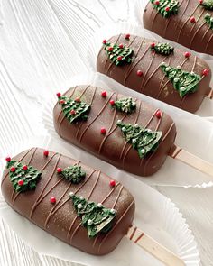 three chocolate covered christmas trees on sticks