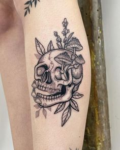 a black and white tattoo with a skull on it