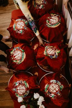 a group of people standing around red cloths