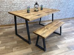 a wooden table with two benches next to it on a hard wood floored floor