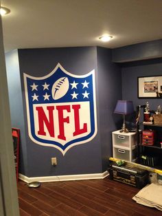 the nfl logo is painted on the wall in this room with hard wood flooring