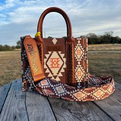 Wrangler Southwestern Print Small Canvas Tote/Crossbody 10.5" X 5" X 8.5" (Crossbody strap 46" ) Allover Aztec pattern print on dual sided canvas Whipstitch details Wrangler logo applique on the front Top zipper closure Inside of the bag includes a zippered pocket and 2 open pockets Double round handle (Drop : 5.75") Detachable/adjustable crossbody strap included Western Fits, Wrangler Accessories, Southwestern Print, Round Handle, Girly Bags, Small Tote Bag