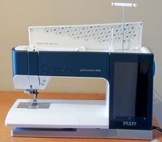 a sewing machine sitting on top of a wooden table