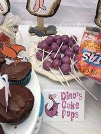 desserts and candies are on display at an outdoor party