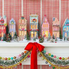 a christmas mantle with decorations and lights on it