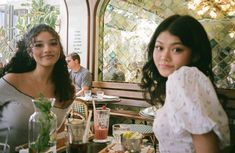 two women sitting at a table in a restaurant