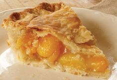 a slice of peach pie on a white plate