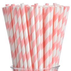 pink and white striped paper straws in a clear cup