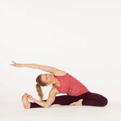 a woman in a red shirt is doing yoga