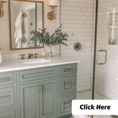 a bathroom with white tile and blue cabinets