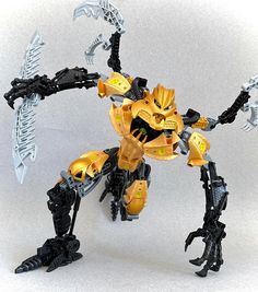 a yellow and black robot that is on a white surface