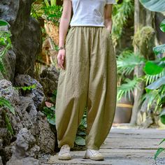 Introducing our Women Elastic Waist Pants in a delightful autumn light yellow. Crafted from a blend of linen and cotton, these pants offer a comfortable and breathable fit. The wide-leg design and mid-waist style make them a versatile addition to any wardrobe. The pants feature a retro casual design, adding a touch of vintage charm to your outfit. With a waist size ranging from 66-96cm/25-37' Hips: 122cm/48' Pants length: 98cm/38', they are designed to accommodate a variety of body types. The me Spring Khaki Harem Pants With Loosely Fitted Hips, Spring Harem Pants With Loosely Fitted Hips In Khaki, Summer Khaki Cotton Wide Leg Pants, Casual Yellow Cotton Wide Leg Pants, Casual Beige Harem Bottoms, Comfortable Green Ankle-length Pants, Relaxed Fit Cotton Wide Leg Pants In Yellow, Khaki Cotton Harem Pants For Summer, Yellow Cotton Wide Leg Pants For Summer