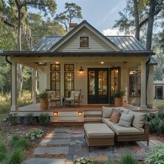 a small house with a porch and seating area