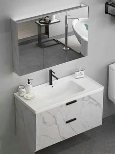 a bathroom with a sink, mirror and toilet in it's center area is shown