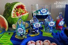 watermelon, grapes and other snacks are on the table for a birthday party