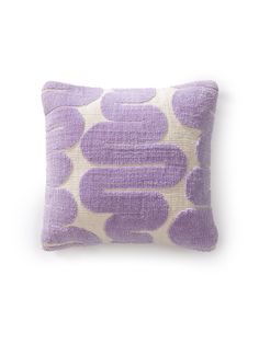 a purple and white pillow with circles on it