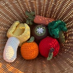 several crocheted fruits and vegetables in a basket