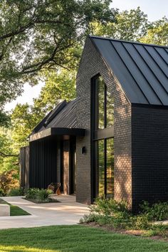 a black brick house with a metal roof