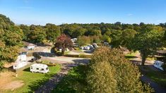 an aerial view of rv parks and campgrounds in the woods, with trees surrounding them