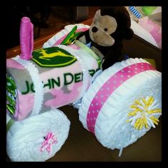 a teddy bear sitting on top of a toy train made out of diapers and blankets