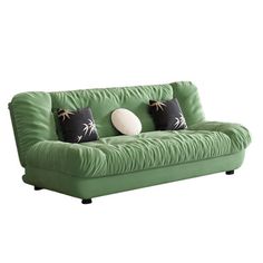 a green couch with black and white pillows