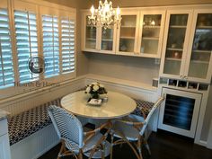 a dining room table and chairs with white cabinets