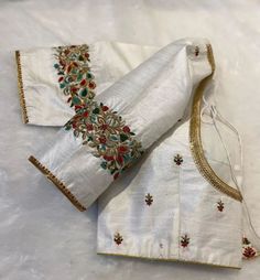 Luxury Resham Embroidery Cream Blouse, Luxury Handwork Silk Thread Blouse Piece, White Silk Blouse Piece With Intricate Embroidery, White Semi-stitched Blouse With Resham Embroidery, White Silk Choli With Floral Embroidery, White Semi-stitched Blouse With Zari Work, Traditional White Embroidered Fabric With Unstitched Blouse, Traditional White Embroidered Fabric For Unstitched Blouse, White Embroidered Semi-stitched Blouse