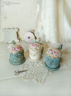 there are several items on the table including hats, scissors and other decorative objects in front of a lace doily