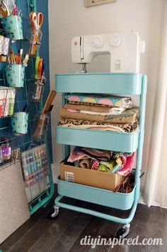 a sewing machine is sitting on top of a cart filled with crafting supplies and scissors