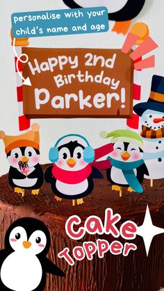 a birthday cake decorated with penguins and a sign