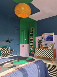 a bed room with a neatly made bed and colorful walls