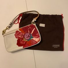 Coach White Leather Handbag With Beautiful, Colorful Flower. Comes With Original Protective Bag. Never Used. Coach Designer Bag As Gift, White Rectangular Pouch With Detachable Strap, White Zipper Pouch Shoulder Bag, Coach Satchel Shoulder Bag Gift, Coach Bags With Removable Pouch As Gift, Spring Coach Pouch Bag, Designer Coach Bags For Spring, Designer White Shoulder Bag Clutch, White Shoulder Bag With Zipper Pouch For Gift