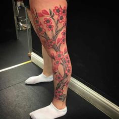 a woman's leg with flowers on it