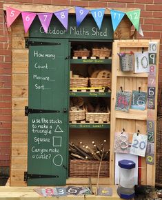 an outdoor math shed with lots of books and toys on it's shelfs