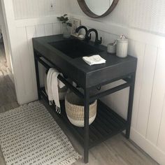 a bathroom with a sink, mirror and rug