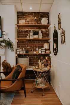 a living room filled with furniture and a brick wall