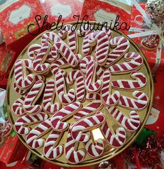 there are many candy canes in the shape of letters on this platter with red and white candies