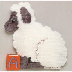 a cross stitch sheep with the letter a on it's back and its tail