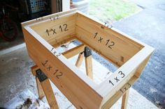 a wooden frame with numbers on it sitting in front of a bike tire storage area