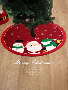 a christmas tree skirt with santa claus and snowmen on it, next to a pine tree