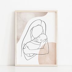 a black and white drawing of a woman holding a baby in her arms on a wall