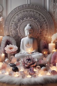 a buddha statue surrounded by candles and flowers