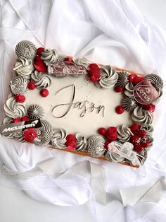 a birthday cake with white frosting and red flowers