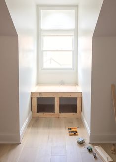 an empty room with white walls and wood flooring is being worked on in the house