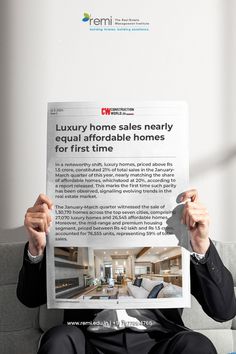 a man sitting on a couch holding up a paper with the words luxury home sales nearly equal