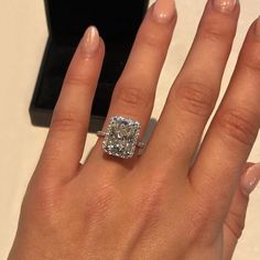 a woman's hand with a diamond ring on it