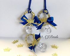 a blue and gold christmas ornament hanging from a string on a white table