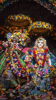 the statue is decorated with flowers and garlands